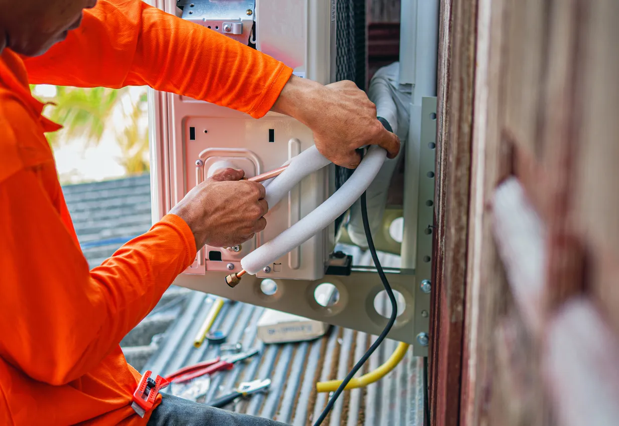 Técnico arregla sistemas de aire acondicionado, Servicio técnico para reparación y mantenimiento de aires acondicionados