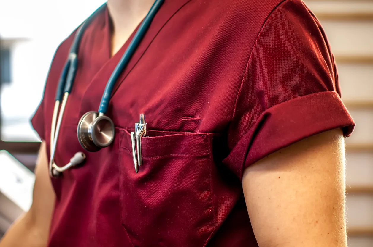 torso de médico con scrub colo vino tinto