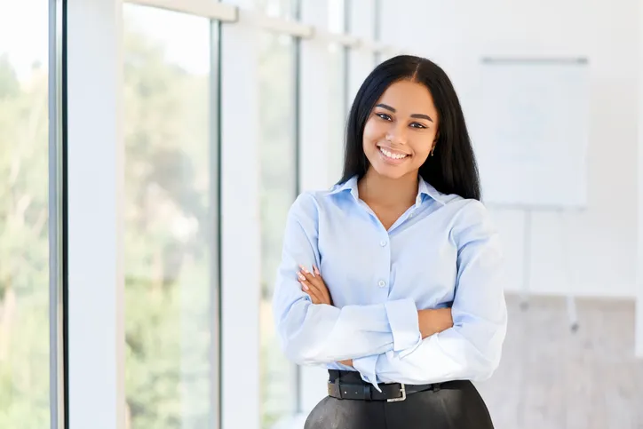 Mujer ejecutiva con uniforme de camisa azul en oficina moderna