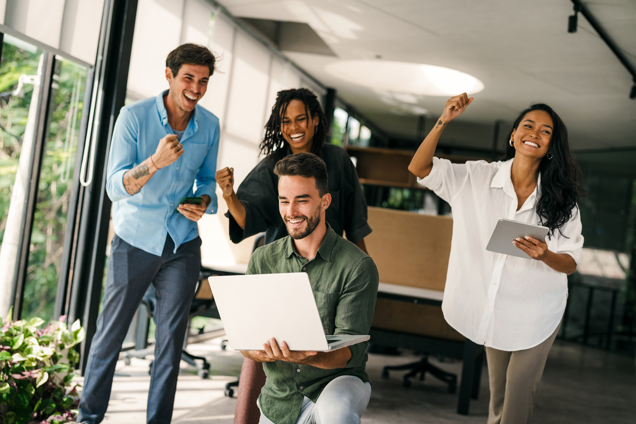 Group of young multi-ethnic startup business team collaborating on project in modern office stock photo