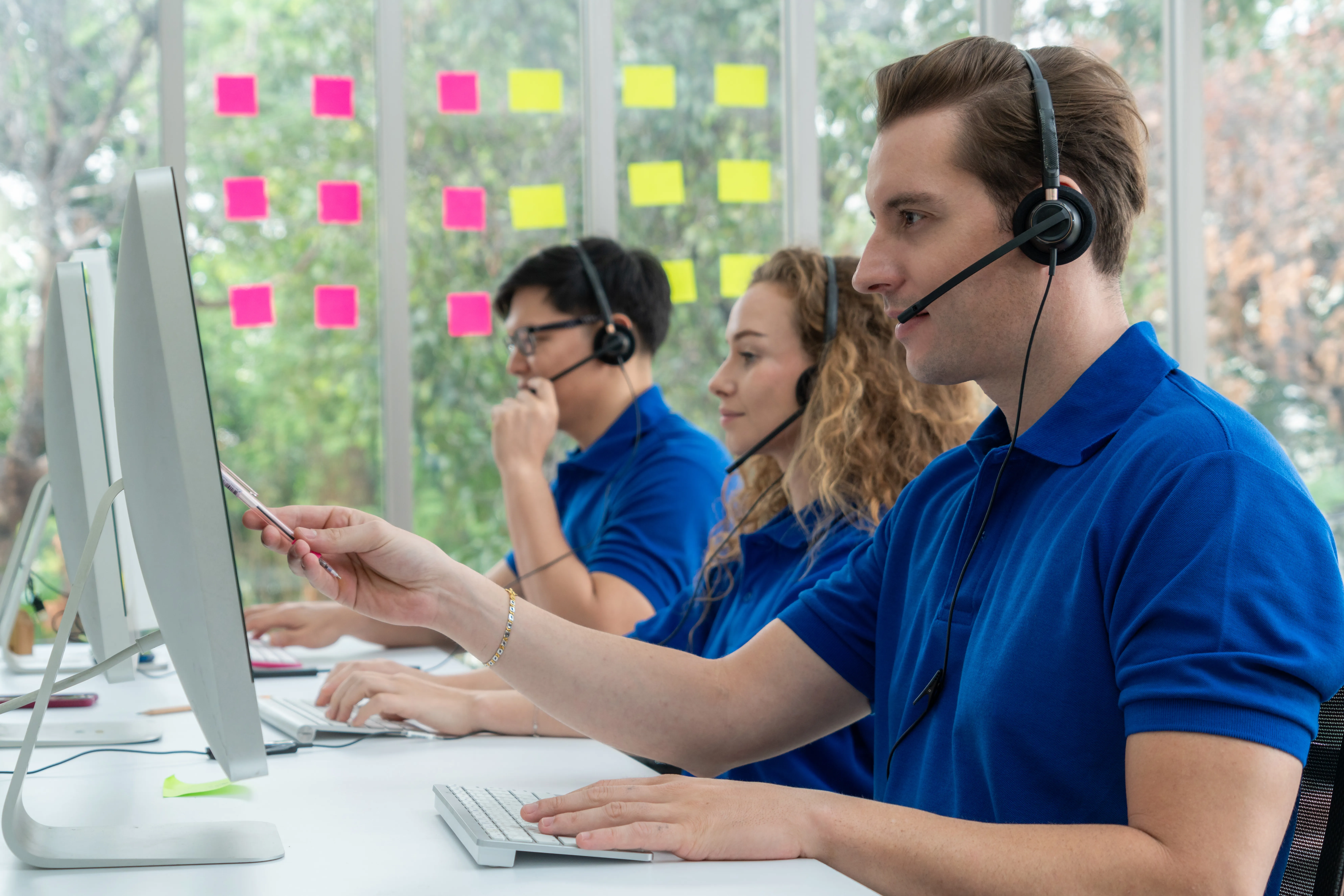 Business people wearing headset working in office with corporate work uniforms