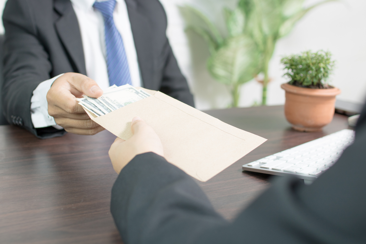 Businessman receiving money, bribery and corruption 