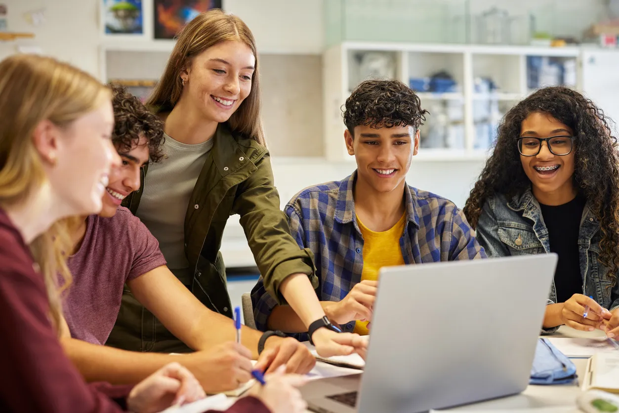 estudiantes de preparatoria trabajando en grupo den salón de clases