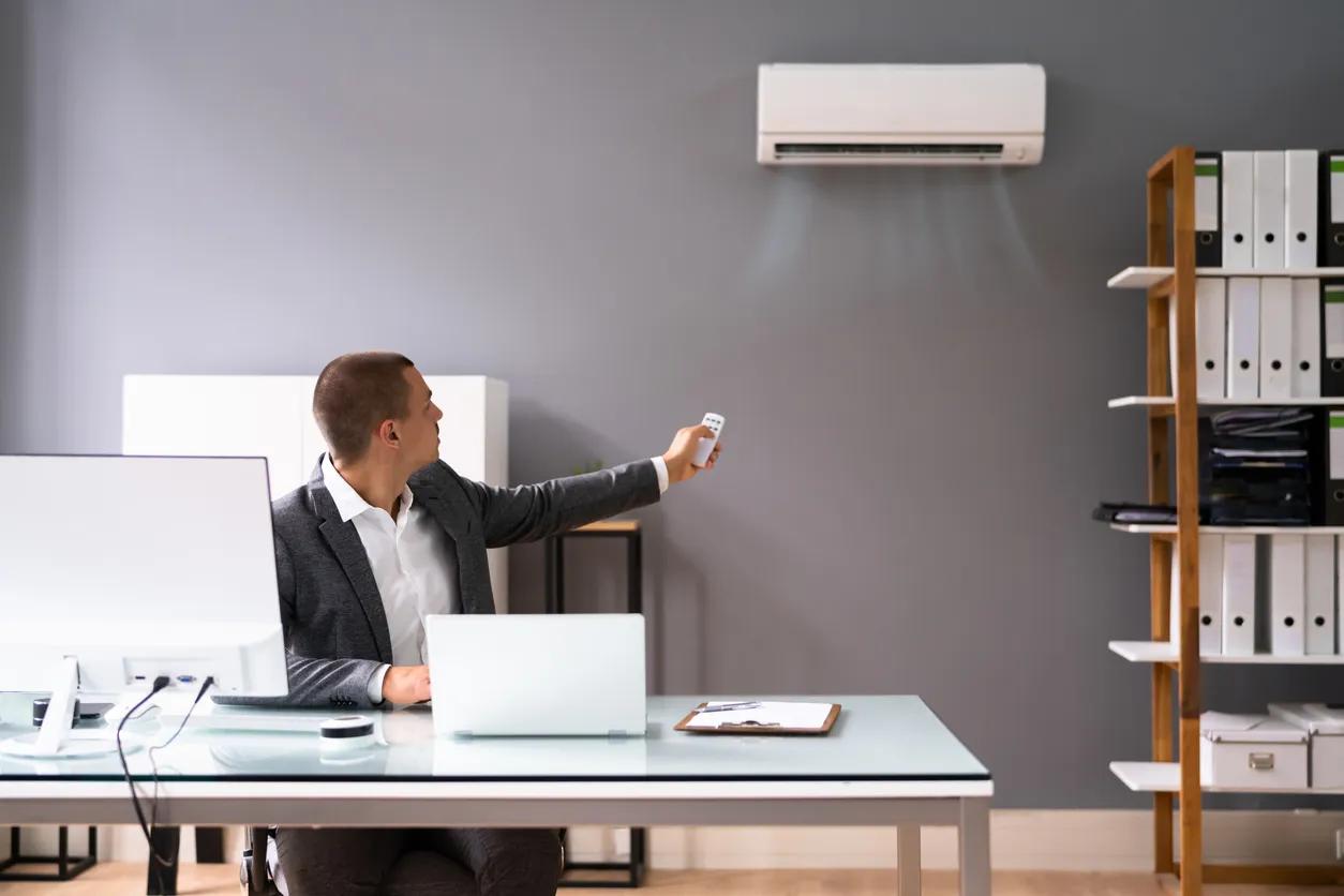 Empresario trabajando en oficina con aire acondicionado