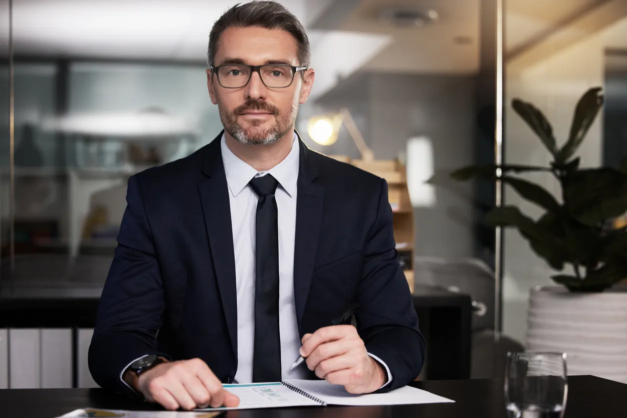 Portrait of a mature businessman sitting at his desk stock photo