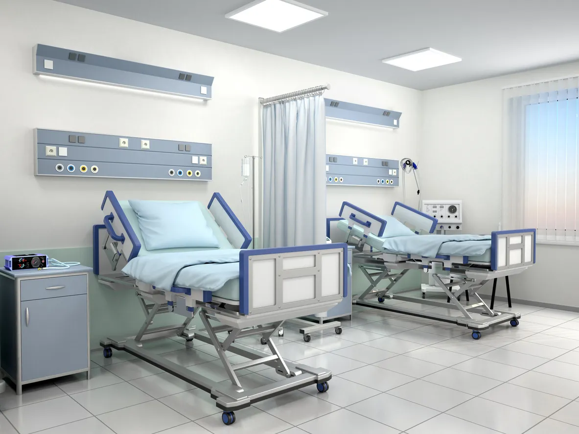 Sala de hospital con dos camas en tonos azules