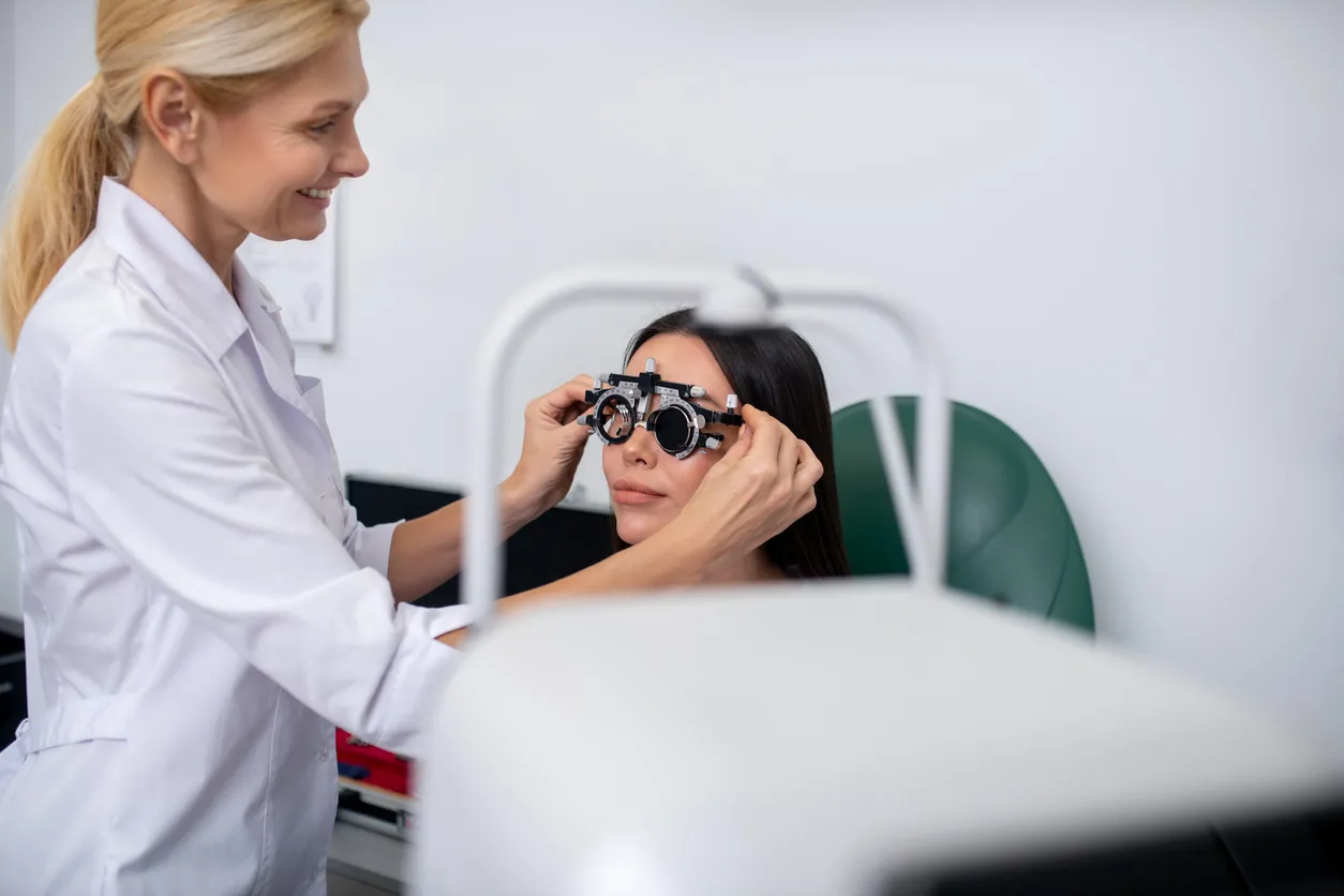 Oftamologa realizando un examen de la vista a empleada