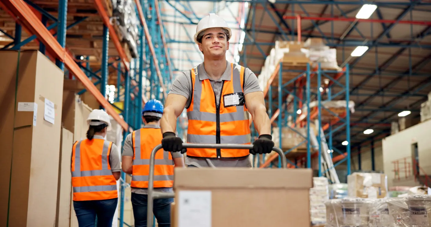 Logística, tranvía y hombre en el almacén con caja, preparación de envíos o gestión de inventario en la entrega.